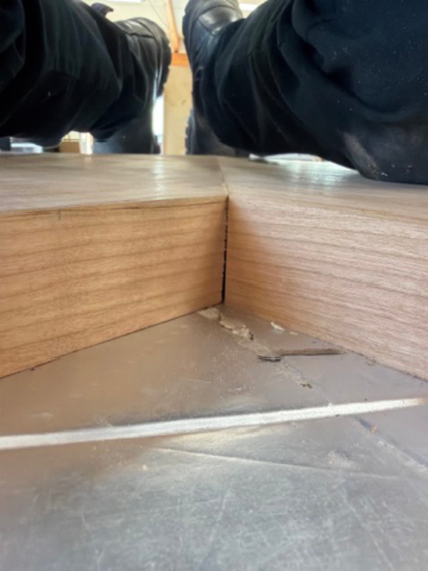 Mitered cherry shelf corner being checked on the shop bench before finishing