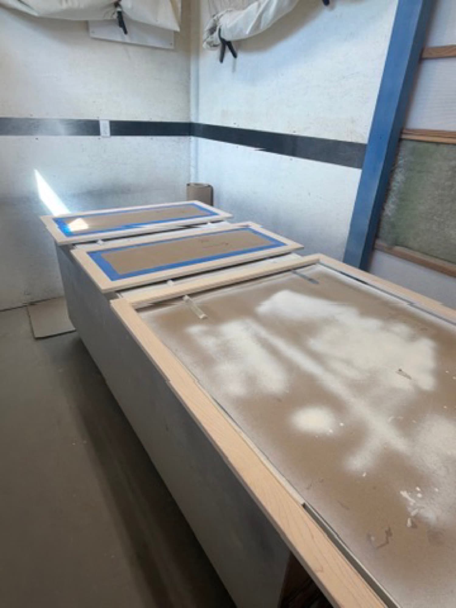Cabinet parts laid out in the Heartwood spray room