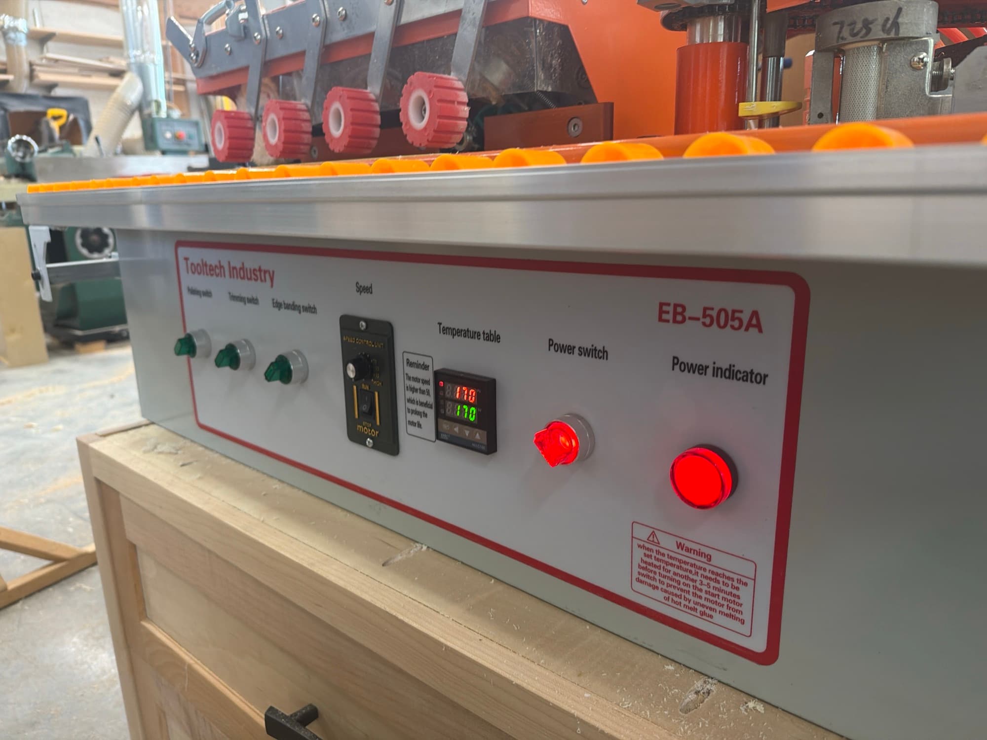 Edge banding machine in the Heartwood Cabinets shop
