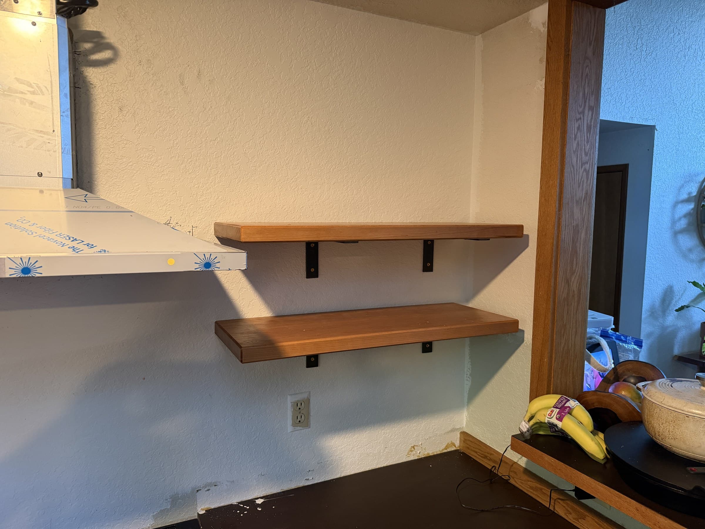 Closer view of the finished cherry shelves and their black supports