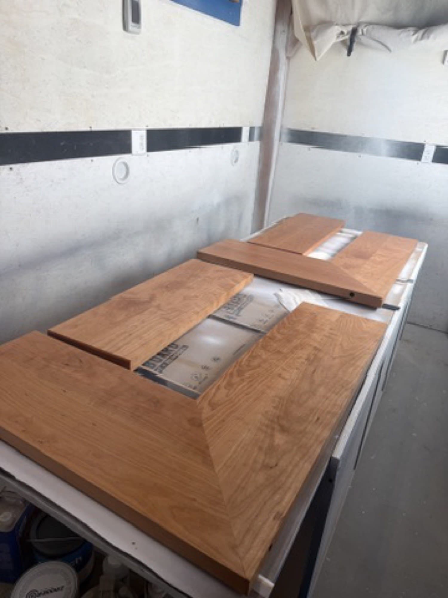 Finished cherry shelf sections laid out in the spray room