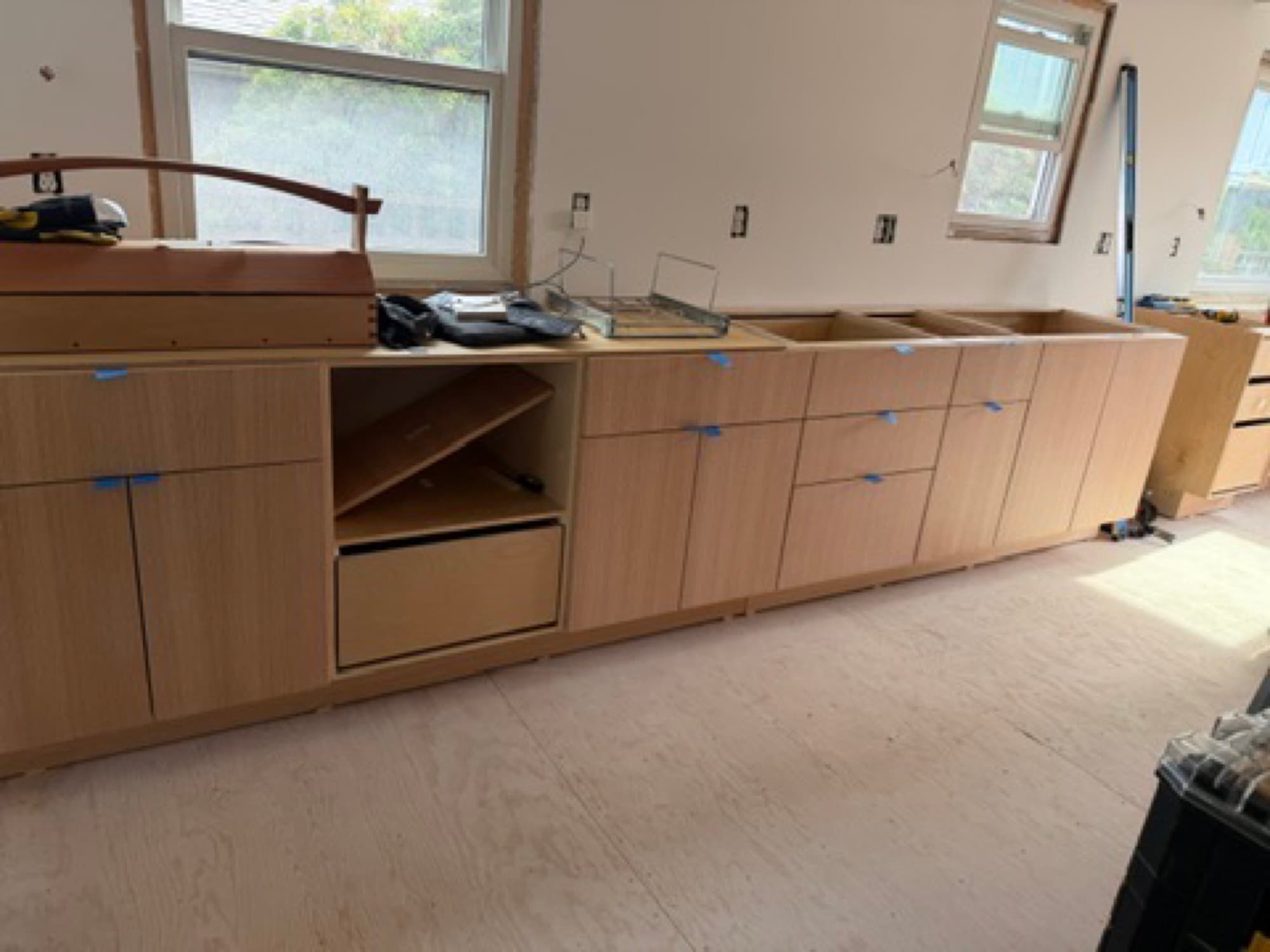 Cabinet run being fitted below a kitchen window