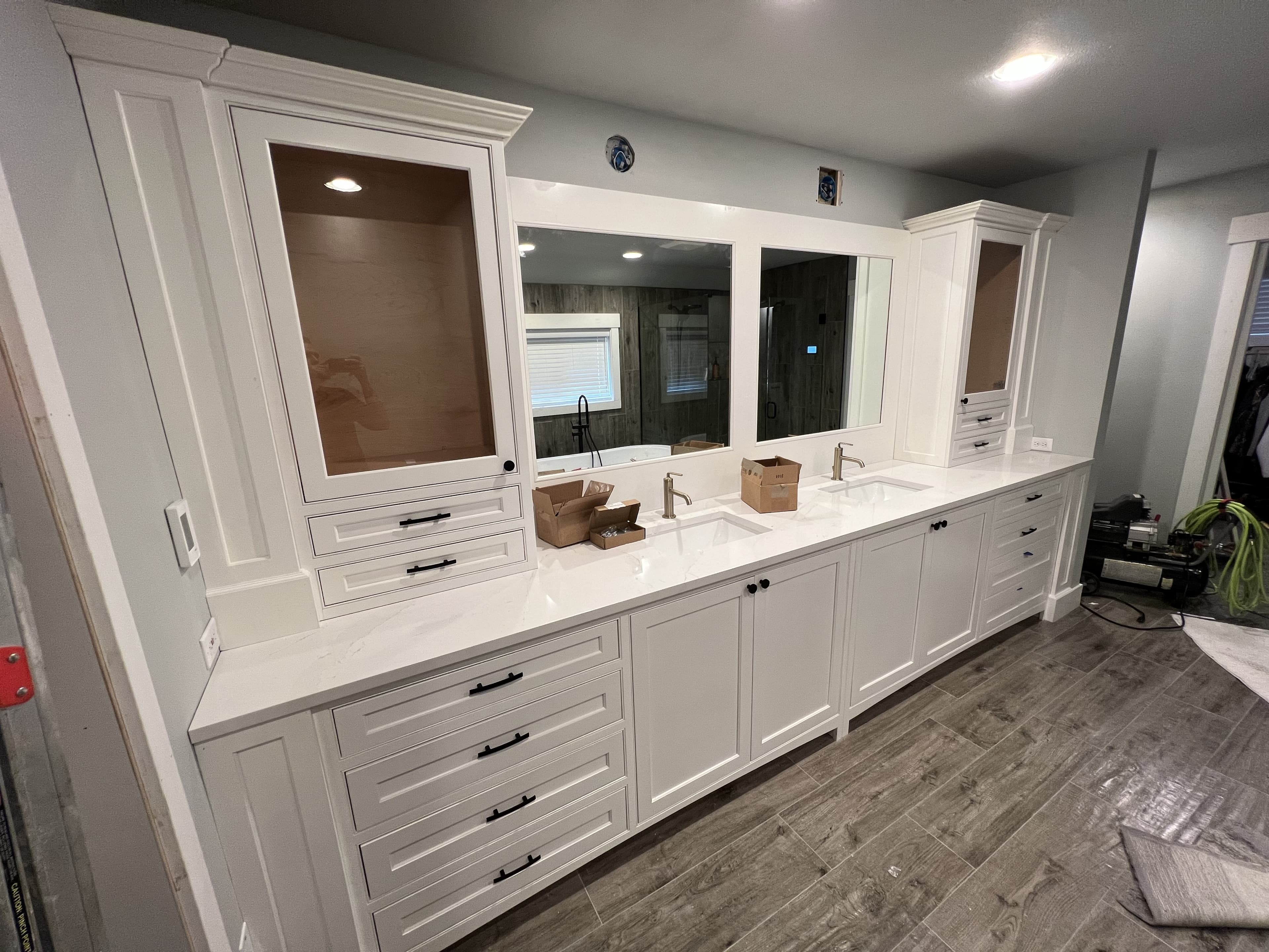 Painted double vanity with tall towers, framed mirrors, and generous drawer storage